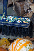 Hand-painted broom with firewood on doorstep