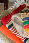 Coloured yarns and folded fabrics in London home,  England,  UK