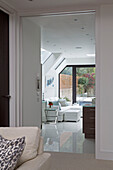 View through doorway to white sofa in contemporary London home   UK