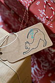 Cat stretching on gift tag at Christmas in Dronfield home  Derbyshire  England  UK