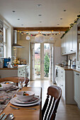 Place setting on dining table in kitchen with fairylights in Dronfield home  Derbyshire  England  UK