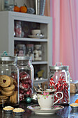 Biscuits and sweets in storage jars with cup and saucer in Laughton kitchen  Sheffield  UK