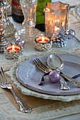 Silverware on plate with lit candles in Laughton home  Sheffield  UK