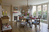 Circular table with lit candles in Sussex dining room  England  UK