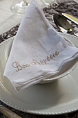 Linen napkin embroidered with 'Bon Appetit' in Berkshire home,  England,  UK