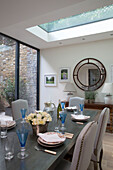 Circular mirror and skylight in dining room extension of London townhouse   England   UK
