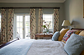 Floral curtains in double bedroom of Warminster country house  Wiltshire  England  UK