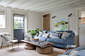 Light blue sofa with coffee table made out of old door in East Dean living room  West Sussex  UK