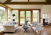 White sofa and matching chairs with coffee table in East Dean conservatory  West Sussex  UK