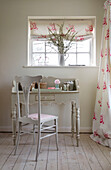 Co-ordinating fabrics with dressing table and chair in East Dean farmhouse  West Sussex  UK
