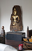 Carved Buddha statue in London home,  England,  UK