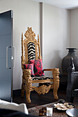 Ornate carved armchair in Oriental London home  England  UK