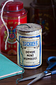 Old fashioned mint humbug tin used for string storage in Surrey home, England, UK