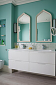 Double basins and mirrors with under sink storage in London home, England, UK