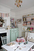 Pastel green sideboard and fabric samples in workroom of Norfolk home England UK