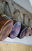 Copper saucepans on nails in Wokingham cottage Berkshire UK