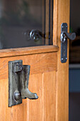 Wellington boot door knocker on wooden front door of Surrey home England UK