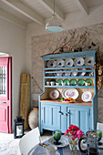 Light blue kitchen dresser with collection of decorative plates in 18th century Ithaca townhouse Greece