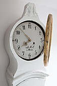 Winding the time on Gustavian clock Surrey England UK