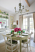Light green dining table with patio doors in Dorset home England UK
