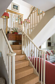 White banister with coir matting staircase in Dorset home England UK