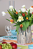 Cut tulip centrepiece on Lechlade dining table Gloucestershire England UK