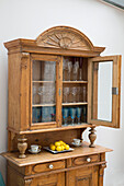 Glassware storage in antique wooden kitchen dresser South West London UK
