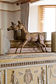 Carved equestrian statue on neoclassical mantlepiece in Arundel home West Sussex England UK