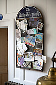 Postcards on noticeboard in Arundel home West Sussex England UK
