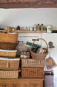Collection of picnic baskets in renovated Victorian schoolhouse kitchen West Sussex England UK