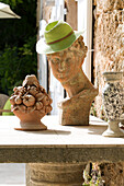 Sunhat on bust with cornucopia on table at exterior of Var farmhouse Provence France