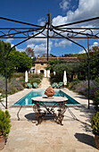 Wrought iron awning at poolside in garden of Var farmhouse Provence France