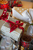 Christmas gifts wrapped with red ribbon in Sussex home England UK