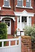 Tiled porch and terracotta path on exterior of brick London house England UK