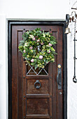 Christmas wreath on wooden front door in Kent England UK