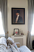 Oil painting of gentleman in top hat in living room detail of London townhouse apartment UK
