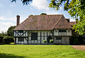 Garden exterior of detached timber framed farmhouse Kent UK