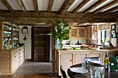 Flower arrangement on worktop in timber framed Kent farmhouse kitchen UK