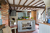 Island unit in open plan beamed kitchen of Grade II listed cottage Hampshire England UK