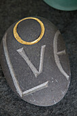 Pebble carved with single word 'LOVE' in Sussex beach house England UK