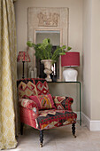 Tapestry covered armchair and fern in corner of Sussex home England UK