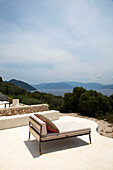 Sunlounger on terrace with coastal view in Ithaca Greece