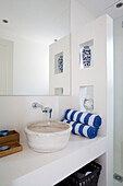 Washbowl and striped towels below large mirror in Ithaca villa Greece