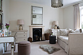 White sofa with mirrored dressing table and fireplace with matching lamps in Worcestershire home England UK