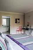 Ghost chair and console with striped patterned rug in Sussex home England UK