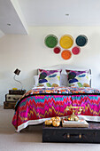 Contrasting patterns in eclectic London bedroom England UK