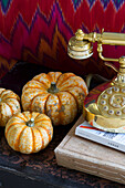 Pumpkin gourds and gold vintage phone in London home England UK