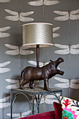 Yawning hippo lampshade with dragonfly wallpaper in Sussex home England UK