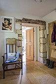 Antique chair with view through exposed stone doorway in Gloucestershire cottage UK