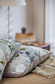 Two floral cushions in bedroom detail in Midlothian cottage Scotland UK